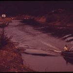 800px TWO FISHERMEN SET OUT FROM A BACKWATER ANCHORAGE AT GRAVOIS MILLS ON THE NORTHERN ARM OF THE LAKE OF THE OZARKS. THE... NARA 551281
