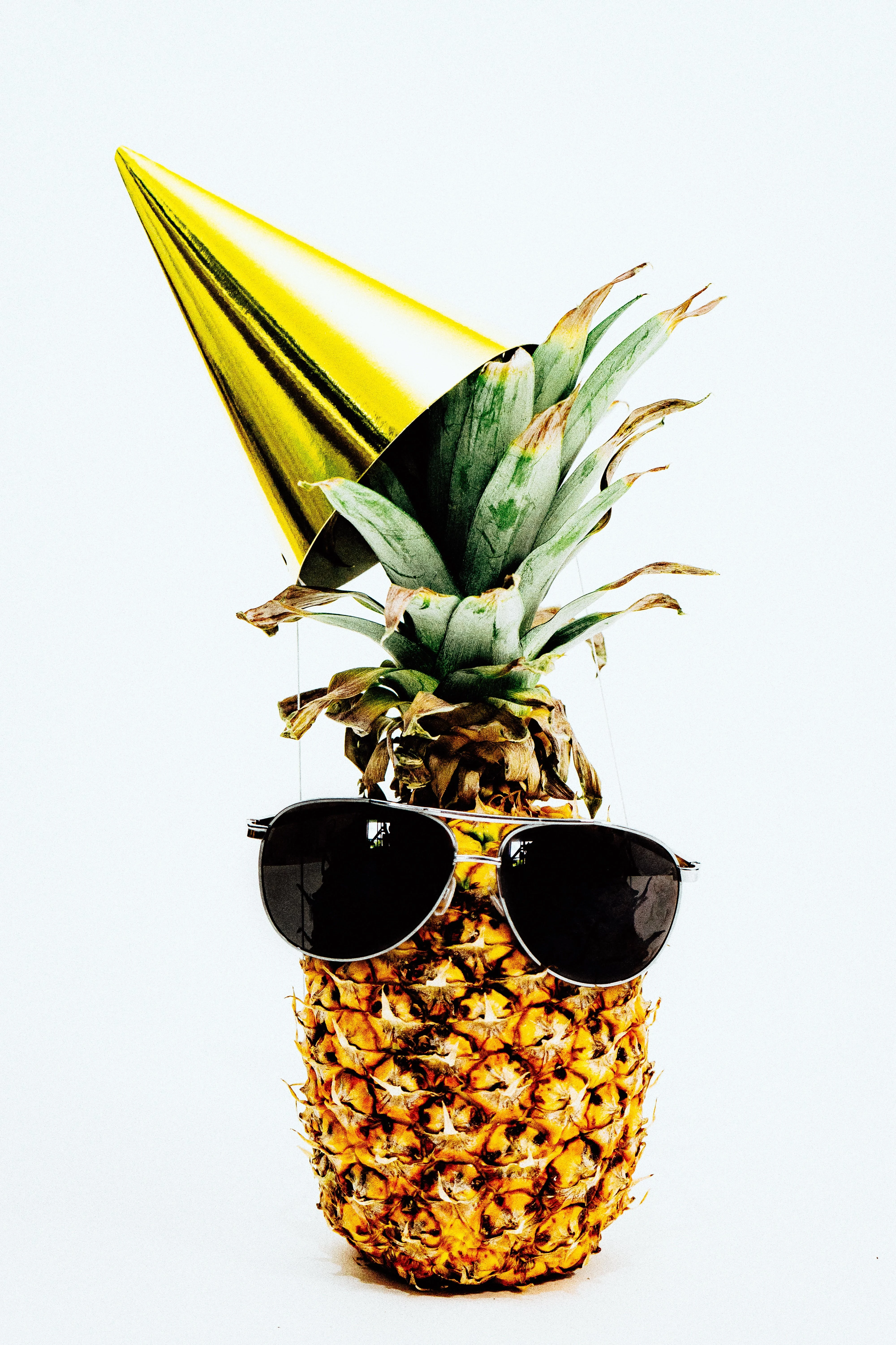 Free Close-up Photo of Pineapple with Party Hat and a Black Sunglasses Stock Photo